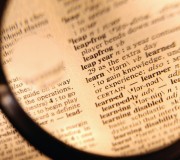 Magnifying Glass over Dictionary